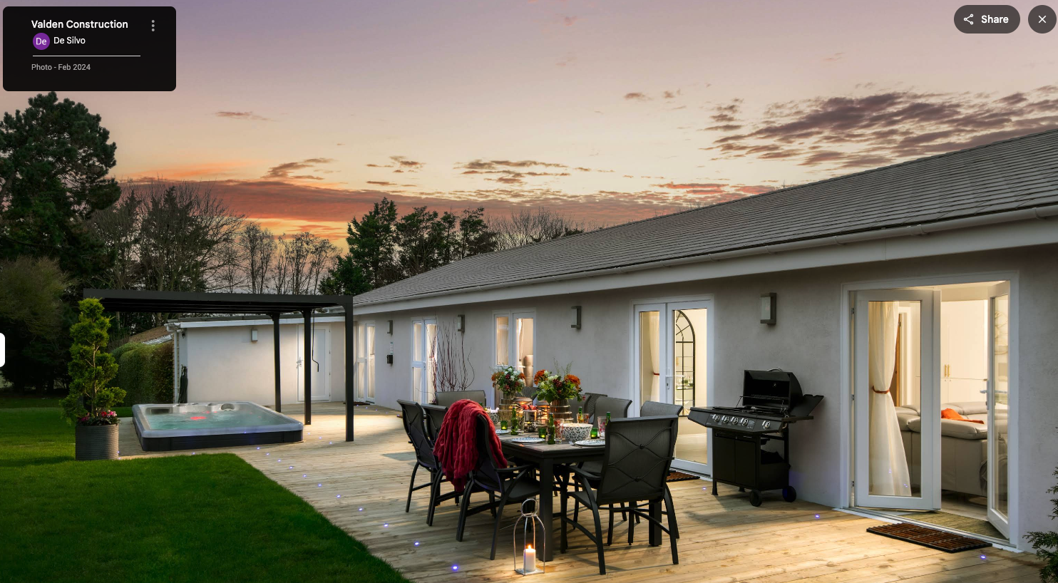 Outdoor decking and terrace area with hot tub at sunset